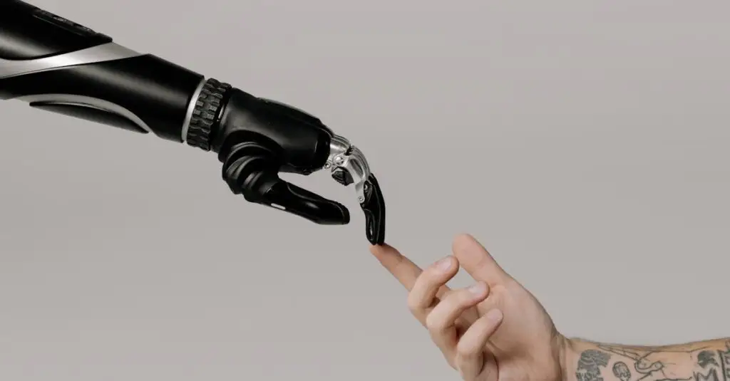 Close-up of a prosthetic arm and a human hand reaching towards each other in harmony.